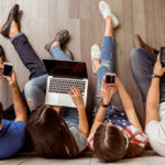 young-people-sitting-on-the-floor-using-a-laptop_365329922